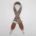 Detail view of ethnic floral embroidered wide bag strap with golden lobster clasps - Beige/Blue With Gold Hook