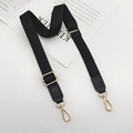 Detail view of adjustable black cotton strap with gold metal buckles and leather ends - Gold Hook / Black