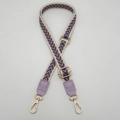Close-up of adjustable woven shoulder strap with purple arrow patterns and gold hardware - Cream Edge Purple + Light Purple Leather