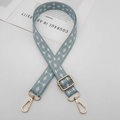 Detail of bohemian woven wide bag strap with teal geometric patterns and gold lobster clasps - Light Green