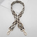Close-up of a wide woven bag strap with brown geometric pattern and gold swivel clips - Apricot White Brown