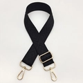 Detail of black adjustable shoulder strap with diamond pattern and gold metal lobster clasps - Black