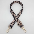 Detailed view of leopard print woven bag strap with golden metal lobster clasps - Black Pink