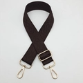 Detail of adjustable dark brown crossbody strap with golden hardware and rhombic pattern - Brown