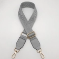 Detail of adjustable wide shoulder strap with light gray jacquard pattern and gold hardware - Light Gray with Gray Patch