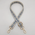 Close-up of adjustable nylon woven shoulder strap with retro geometric patterns and gold hooks - Beige With Blue Dots