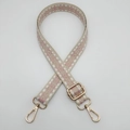 Detail of adjustable nylon bag strap with pink geometric pattern and gold metal hooks - Beige Pink