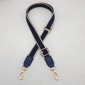 Detail of adjustable dark blue crossbody strap with Greek key pattern and gold metal hooks - Blue + Blue Leather