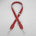 Close-up of red and white maze pattern bag strap with gold hooks and leather ends - Red + Red Leather