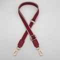 Detail of adjustable wide shoulder strap with red geometric Greek key pattern and gold buckles - Wine Red + Wine Red Leather