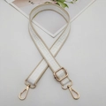 Detail of adjustable woven bag strap with beige Greek key pattern and gold metal hardware - Gold Hook / Apricot Edge White