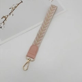 Detail of woven wrist strap with pink leaf patterns and golden thread embroidery - Pink With Gasket