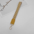 Close-up of leaf pattern woven wrist strap with yellow leather end and gold metal hook - Yellow With Patch