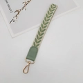 Close-up of cream wrist strap with green leaf patterns and gold metal lobster clasp - Matcha Green With Patch
