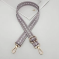 Detail of adjustable lilac purple nylon bag strap with white arrow pattern and gold metal hooks - Light Purple