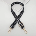 Dettaglio della tracolla regolabile in nylon bianco e nero con moschettoni in metallo dorato - Gancio Dorato / Nero