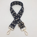 Detail of adjustable navy jacquard strap with floral embroidery and golden metal hooks - Blue Beige Edge Black