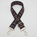 Detail of adjustable blue jacquard strap with vintage patterns and gold metal buckles - Black Brown Edge Blue