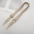 Close-up of adjustable beige PU leather shoulder strap with elegant gold metal hardware - Off White