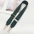 Macro detail of dark green PU leather bag strap with polished gold-tone metal hardware - Green