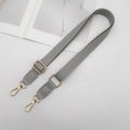 Close-up of adjustable grey PU leather shoulder strap with golden metal lobster clasps - Gray