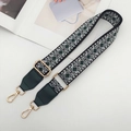 Detail of adjustable geometric jacquard strap with dark green leather and gold hardware - Gold Hook / Black/Green with Green Leather