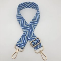 Close-up of blue geometric woven bag strap with polished light gold metal buckles - Light Blue / Gold