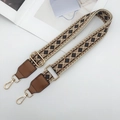 Close-up of geometric ethnic woven wide bag strap with golden metal swivel hooks - Beige/Brown/Black with Caramel Leather