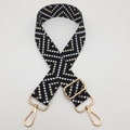 Close-up of bohemian chevron pattern woven strap with premium gold metal hardware - Black / Gold