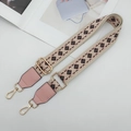 Macro view of geometric woven strap with pink leather ends and golden metal lobster clasps - Pink/Coffee with Pink Leather