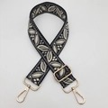 Close-up of ethnic embroidered guitar strap for bags with adjustable gold metal hardware - Grey With Black Base