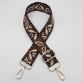 Detail of adjustable guitar style bag strap with leaf pattern and gold metal hooks - Black Brown