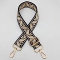 Detailed view of bohemian embroidered guitar strap with gold hardware hooks and buckle - Black Base Nude Pink