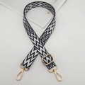 Detail of adjustable black and white geometric woven strap with golden metal hardware - Black & White