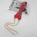 Detail of red and white wave pattern woven strap with gold chain and red leather trim - Red