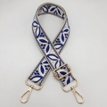 Detail of adjustable woven guitar-style shoulder strap with blue leaf pattern and gold hardware - Cream Base Royal Blue