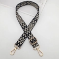 Detail of adjustable embroidered bag strap with black geometric patterns and gold clips - Black & Creamy White