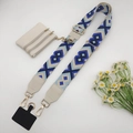 Detailed view of bohemian woven crossbody strap with white mini pouch and gold hardware - Beige Blue Gold Hook Set