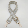 Detail of adjustable wide guitar style shoulder strap with gold metal lobster clasps - Beige Base Light Grey White