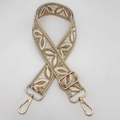 Close-up of ethnic style embroidered strap with gold metal hooks and leaf pattern detail - Beige Base Khaki