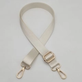 Detail of adjustable cream nylon bag strap with gold metal hooks and sliding buckle - Gold Hook / Off White