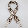 Close-up of vintage jacquard pattern shoulder strap with gold metal lobster clasps - Beige Base Light Coffee