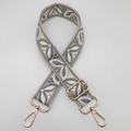 Detail of adjustable embroidered bag strap with grey leaf patterns and gold metal buckles - Beige Base Medium Grey White