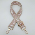 Detail of adjustable woven shoulder strap with pink floral pattern and gold metal hooks - Beige Base Sakura Pink