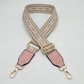 Detail of wide woven strap with pink leather accents and golden metal hardware buckles - White Light Pink With Pink Leather