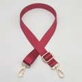 Detail of adjustable burgundy nylon bag strap with gold metal lobster clasps and buckle - Gold Hook / Burgundy
