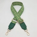 Close-up of green geometric woven bag strap with leather ends and golden metal clips - Grass Green With Grass Green Leather