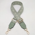 Detail of adjustable geometric woven bag strap with green leather and gold hardware - Matcha Green with Matcha Green Leather