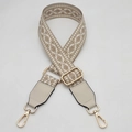 Detail of adjustable woven ethnic strap with beige geometric patterns and gold metal hooks - White Edge Apricot With Cream Leather