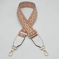 Close-up of geometric woven strap with white leather ends and gold metal hooks - Orange With White Leather